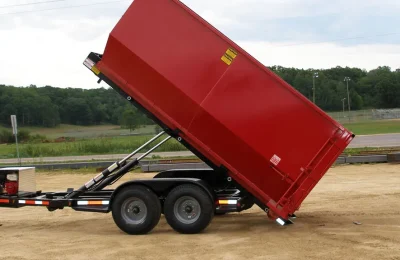Speedy Dumpsters truck delivering a roll off container