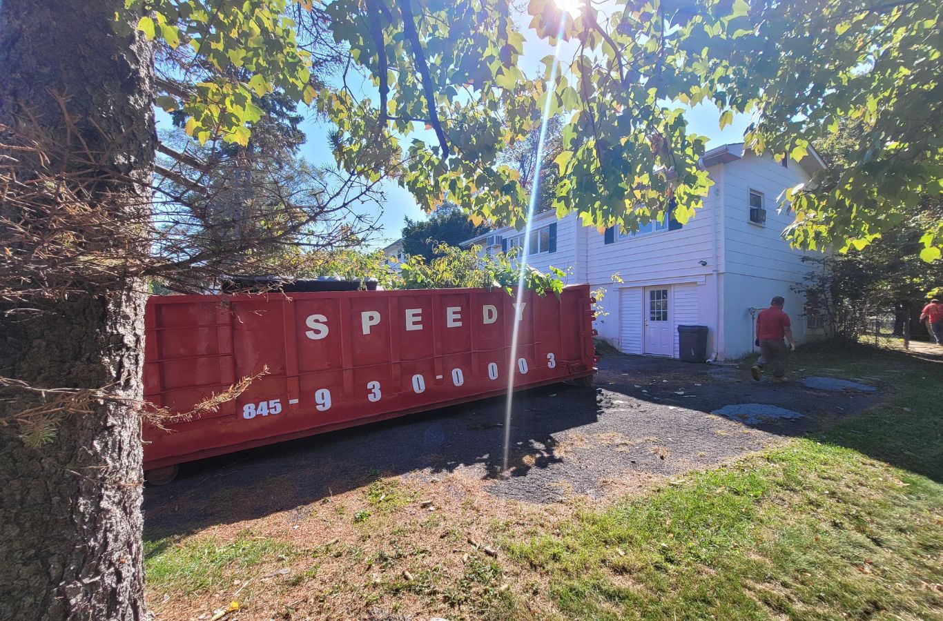 Dumpster being loaded with debris: Speedy Dumpsters